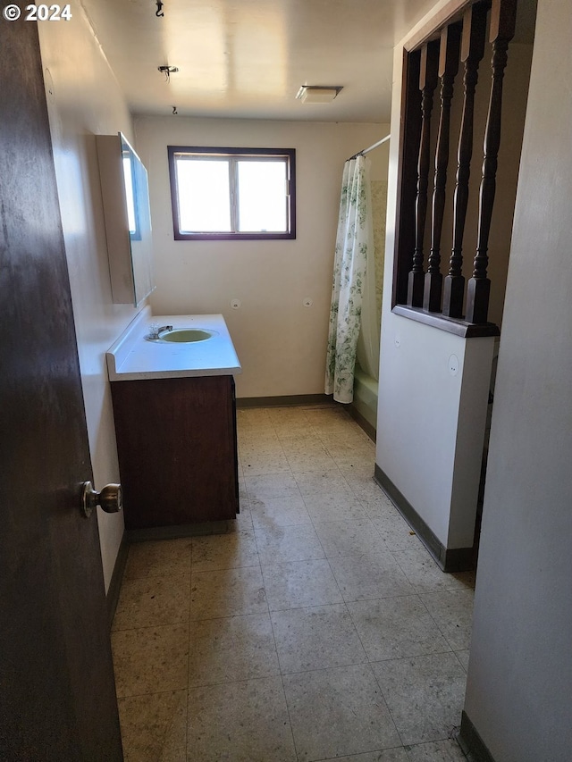 bathroom featuring vanity, shower / bath combo, and tile floors