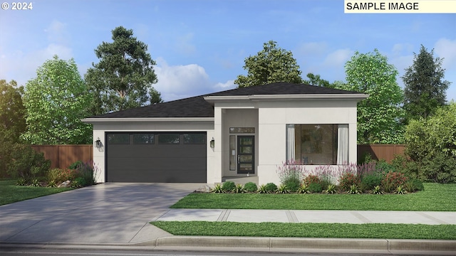 view of front of property with a garage and a front lawn