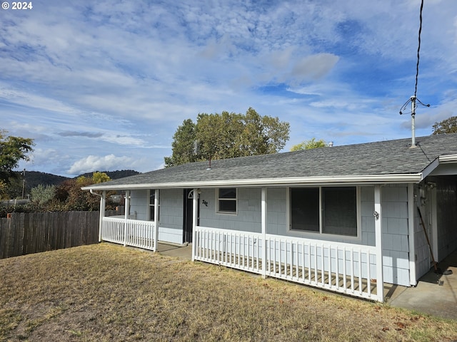 single story home with a front lawn and a porch