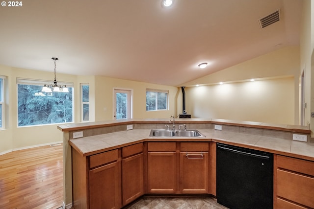 kitchen with sink, decorative light fixtures, dishwasher, a chandelier, and lofted ceiling