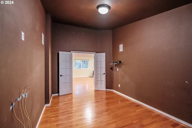 hallway with light hardwood / wood-style floors