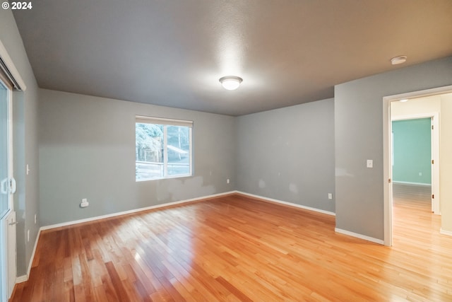 unfurnished room with hardwood / wood-style flooring