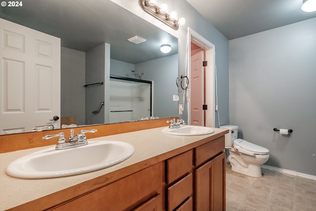 bathroom with tile patterned floors, toilet, an enclosed shower, and vanity