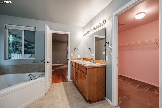 bathroom featuring vanity and a bath