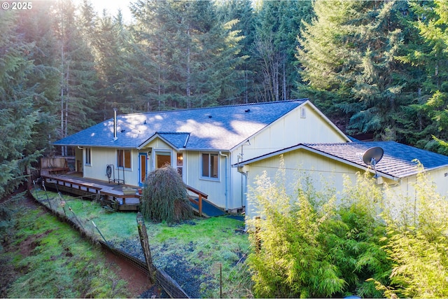 view of front facade featuring a front yard and a deck