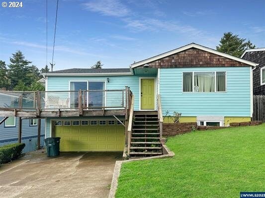 view of front facade with a front lawn and a garage