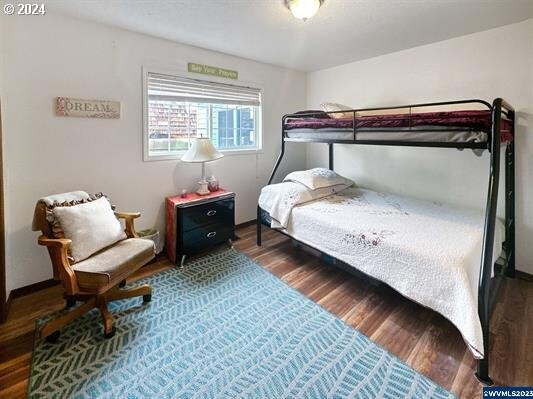 bedroom featuring wood-type flooring and a textured ceiling