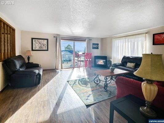 living room with hardwood / wood-style floors and a textured ceiling