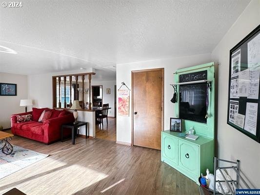 living room featuring hardwood / wood-style flooring and a textured ceiling