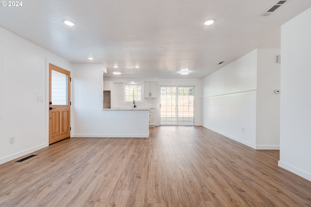 unfurnished living room with light wood-type flooring