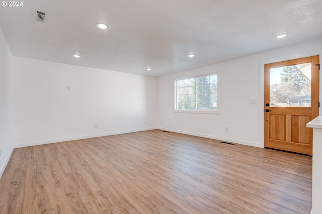 interior space with plenty of natural light, light hardwood / wood-style floors, and a textured ceiling