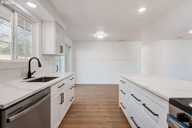 kitchen with white cabinetry, sink, light wood-type flooring, and appliances with stainless steel finishes