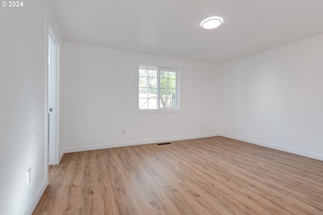 spare room featuring light hardwood / wood-style flooring