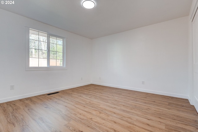 spare room featuring light wood-type flooring