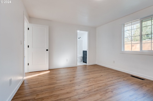 empty room with light hardwood / wood-style floors