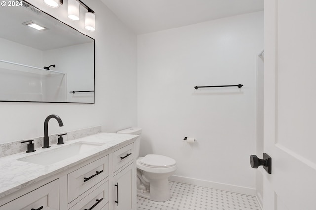 bathroom with walk in shower, vanity, and toilet