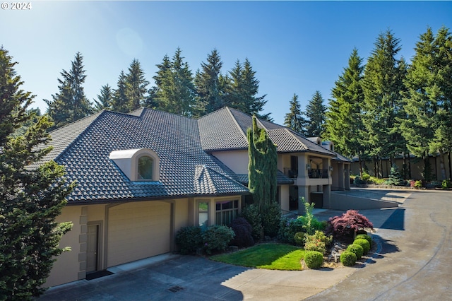 27050 SW Petes Mountain Rd, West Linn, OR 97068 - view of front of home with stucco siding, driveway, a tiled roof, and a garage