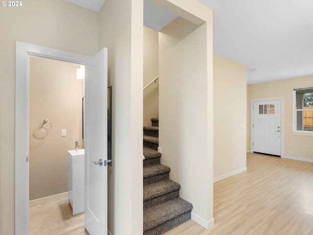 stairway with hardwood / wood-style floors