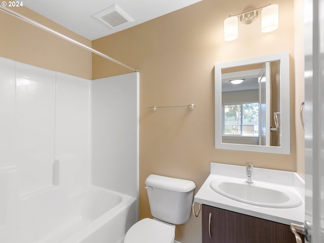 full bathroom featuring vanity, bathing tub / shower combination, and toilet