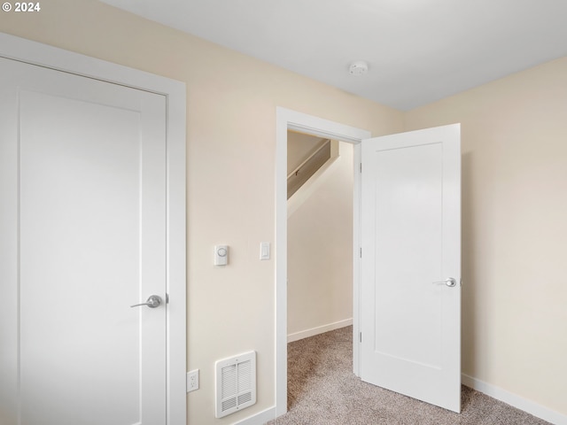 unfurnished bedroom featuring light colored carpet