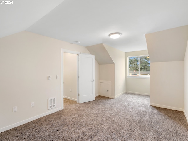 additional living space with carpet floors and lofted ceiling