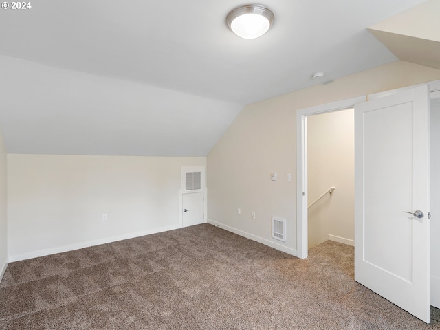 additional living space featuring carpet and lofted ceiling