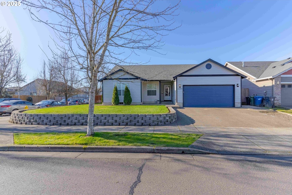 ranch-style house with a garage and a front yard