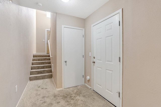 entrance foyer with light carpet