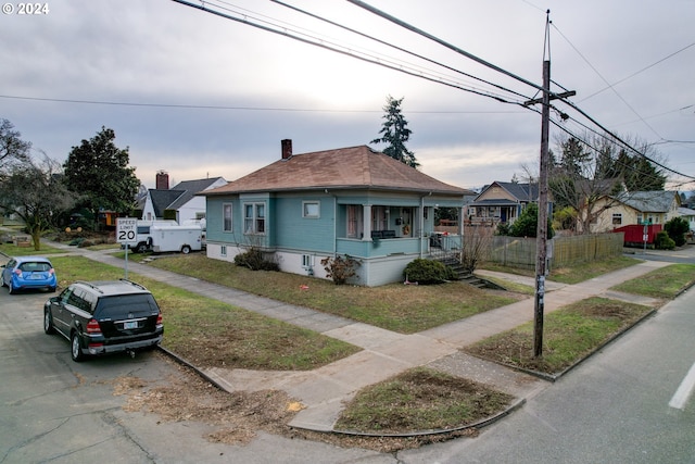 bungalow-style house featuring a front yard and a porch