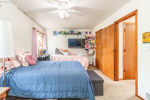 carpeted bedroom with ceiling fan