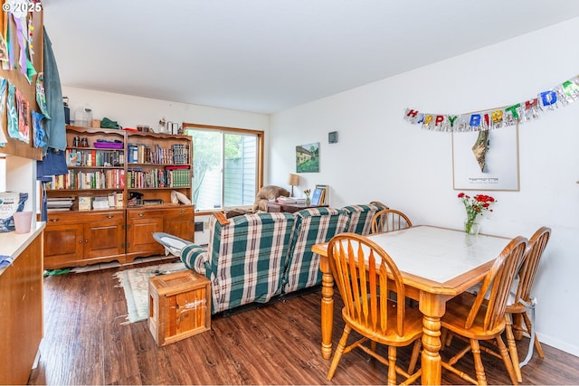 dining space with dark wood-type flooring