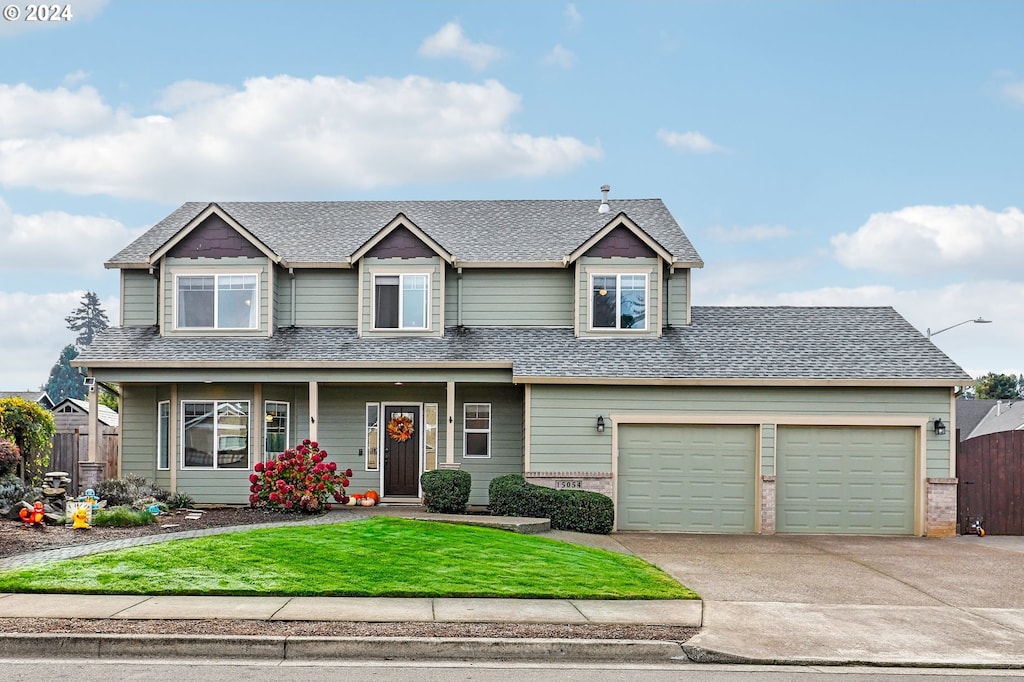 craftsman-style home with a garage and a front lawn