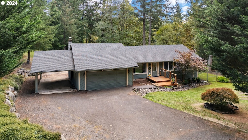 view of front of house with a carport, a front yard, and a garage