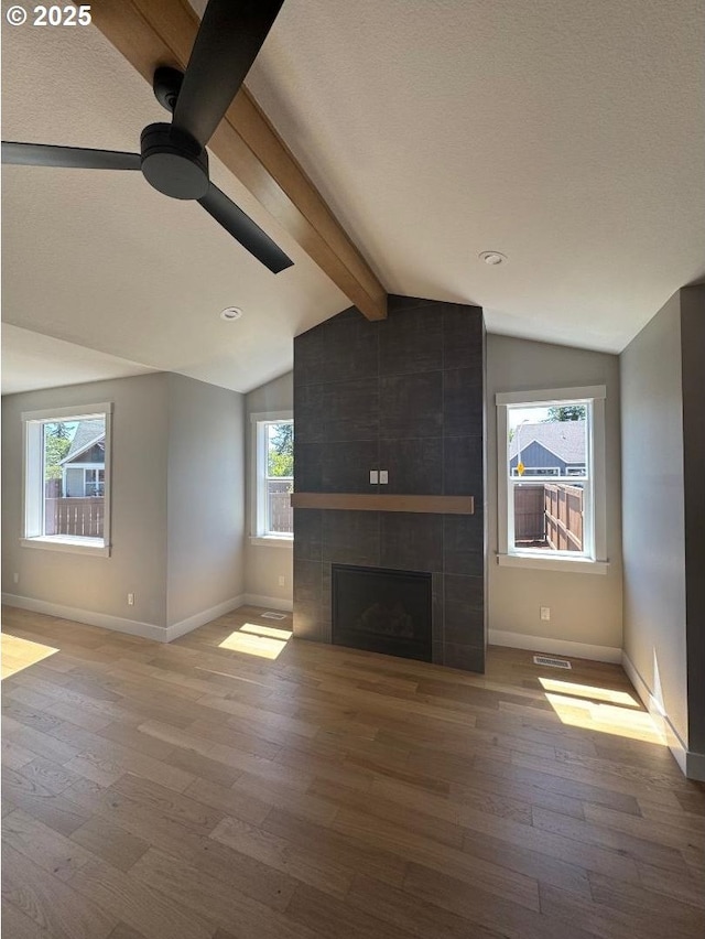 1918 S Holly St, Canby, OR 97013 - unfurnished living room with ceiling fan, hardwood / wood-style flooring, baseboards, and a tiled fireplace