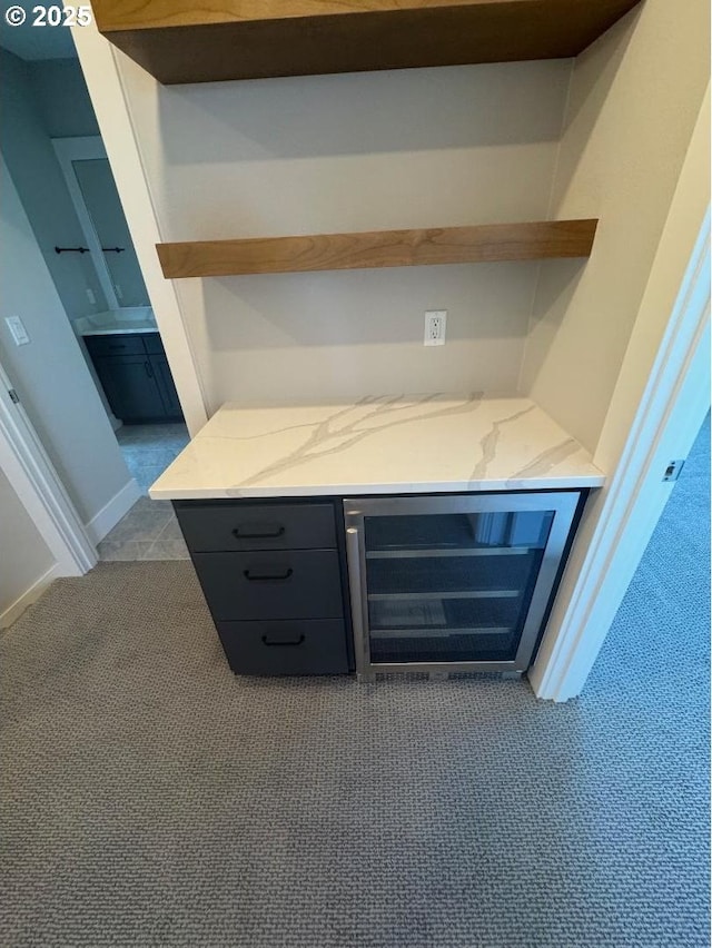 1918 S Holly St, Canby, OR 97013 - unfurnished living room with wine cooler, dark colored carpet, baseboards, and a dry bar