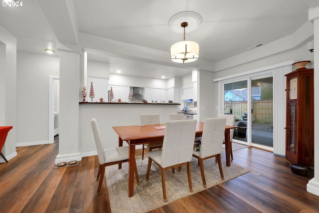 dining space featuring dark wood-type flooring