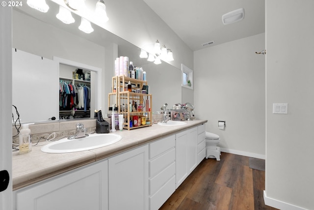 bathroom featuring vanity, toilet, and wood-type flooring