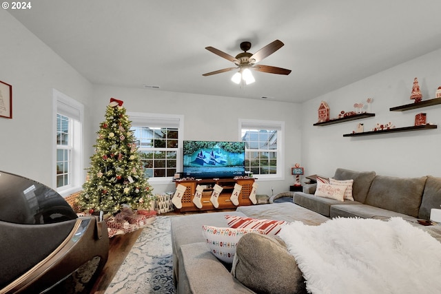 living room featuring hardwood / wood-style floors and ceiling fan