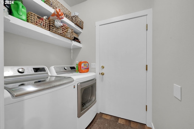 clothes washing area with dark hardwood / wood-style flooring and separate washer and dryer