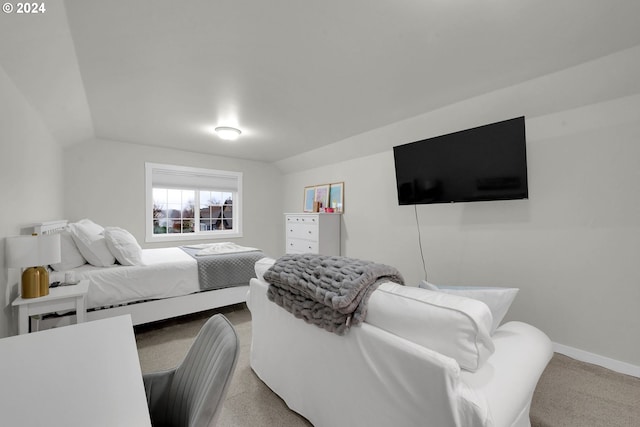 bedroom with light carpet and vaulted ceiling