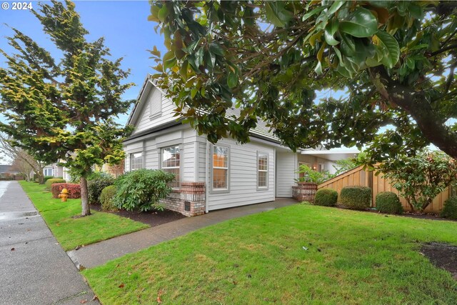 view of property exterior featuring a lawn