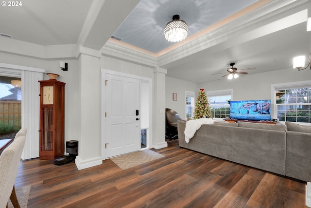 living room featuring dark hardwood / wood-style floors, a raised ceiling, and ceiling fan with notable chandelier