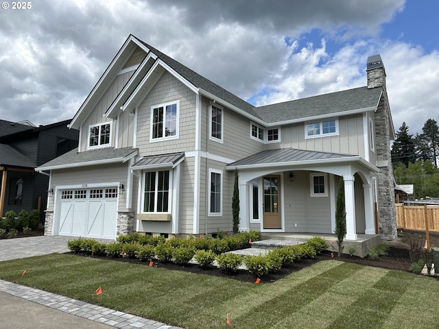 view of front of property with board and batten siding, concrete driveway, a chimney, and a garage
