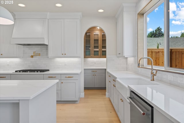 1218 9th St Lot 3, West Linn, OR 97068 - kitchen featuring stainless steel appliances, a sink, custom range hood, light wood-style floors, and light stone countertops