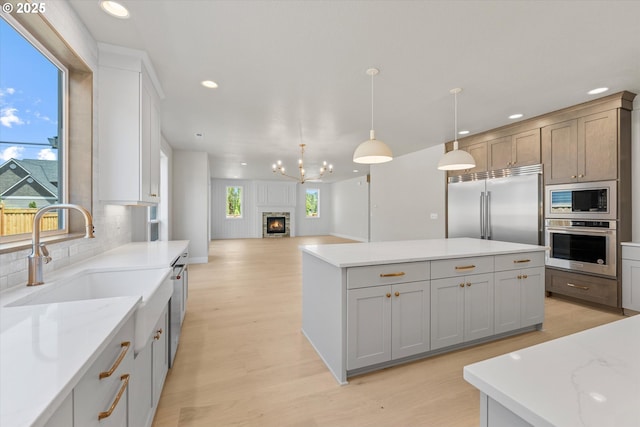 1218 9th St Lot 3, West Linn, OR 97068 - kitchen with built in appliances, a sink, recessed lighting, light wood-style floors, and a kitchen island