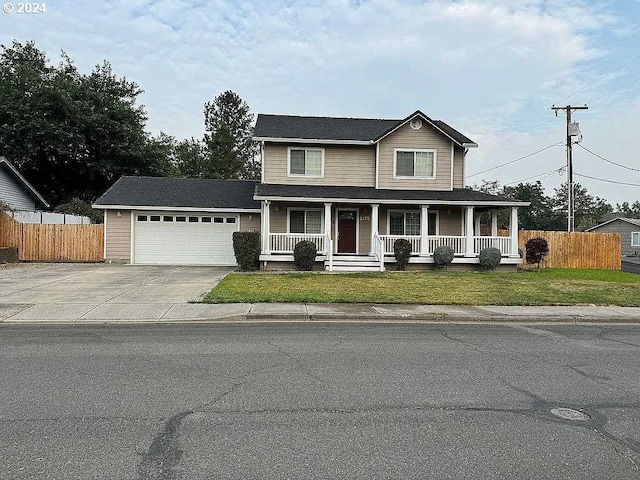 view of front of home with a garage, a porch, and a front yard