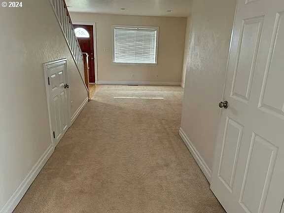 corridor with light colored carpet