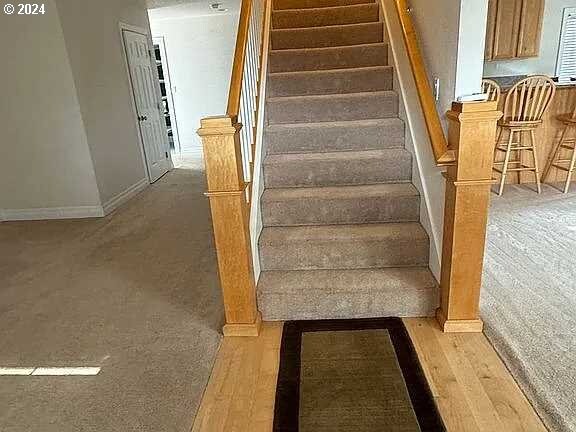 stairway with hardwood / wood-style floors