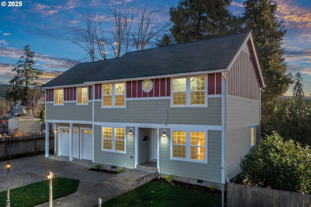 view of front of property with driveway, a shingled roof, a garage, and fence