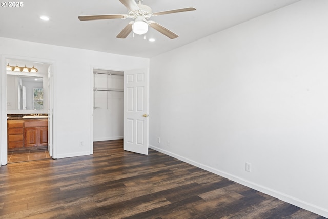 unfurnished bedroom with dark wood-type flooring, a closet, recessed lighting, and baseboards